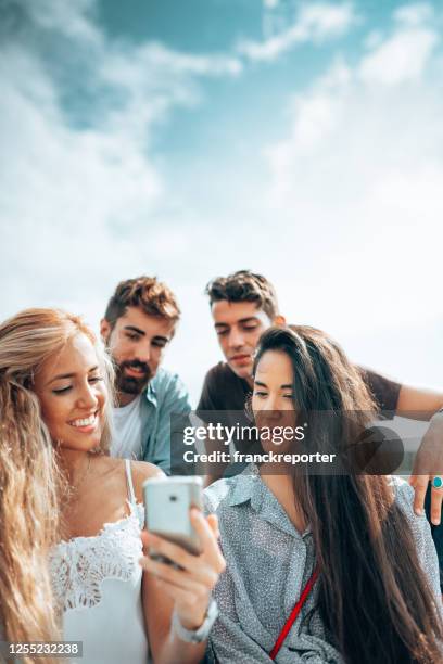 people watching the smartphone to watch videos - z com stock pictures, royalty-free photos & images
