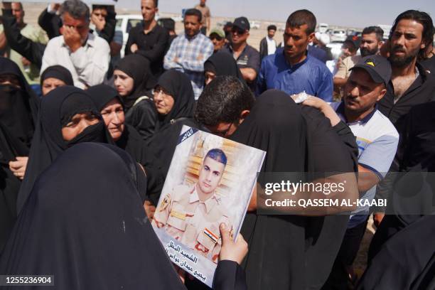 Iraqi mourners attend the funeral of inmates of the Badush prison, killed in Mosul by Islamic State group jihadists in 2014 and found in mass graves...
