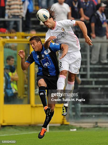 German Gustavo Denis of Atalanta and Matias Silvestre of Palermo jump for a header during the Serie A match between Atalanta BC and US Citta di...