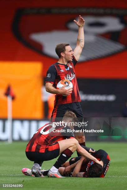 Adam Smith of AFC Bournemouth goes down injured as David Brooks checks on him and Dan Gosling calls for the medical team during the Premier League...