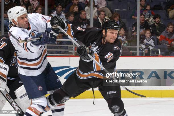 Adam Oates of the Edmonton Oilers and Todd Rohloff 38 of the Washington Capitals fight for position during a NHL hockey game at MCI Center on January...