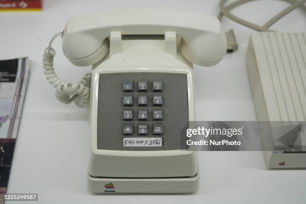 Vintage touch tone phone is seen with an Apple modem at the Apple Museum on 16 March, 2023 in Warsaw, Poland. Wednesday will mark the UN Wolrd...