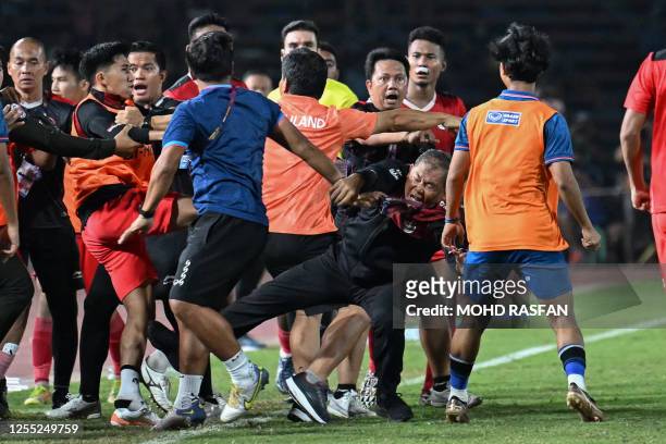 Fight breaks out on the sidelines of the men's football final match between Thailand and Indonesia during the 32nd Southeast Asian Games in Phnom...