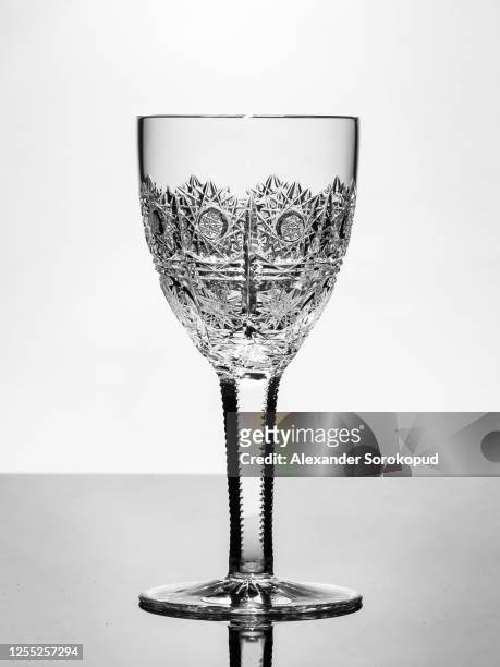 beautiful crystal wine glass isolated, light reflected in engraved pattern - crystal glasses stock pictures, royalty-free photos & images