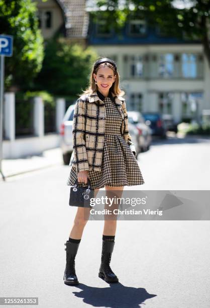 Alexandra Lapp is seen wearing a total look from the Dior 2020 summer collection, D-Trap Ankle Boots from Dior and Lady Dior bag in black, Prada...