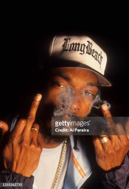 Rapper Snoop Dogg smokes a blunt and gives the middle finger obscene gesture when he appears in a portrait taken on July 13, 1999 in New York City.