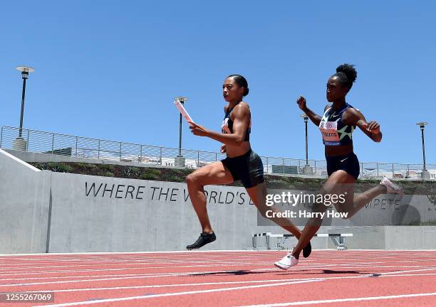 Allyson Felix takes a handoff from Tianna Bartoletta on their way to a first place finish in the women's 3 x 100 meter relay during the Weltklasse...
