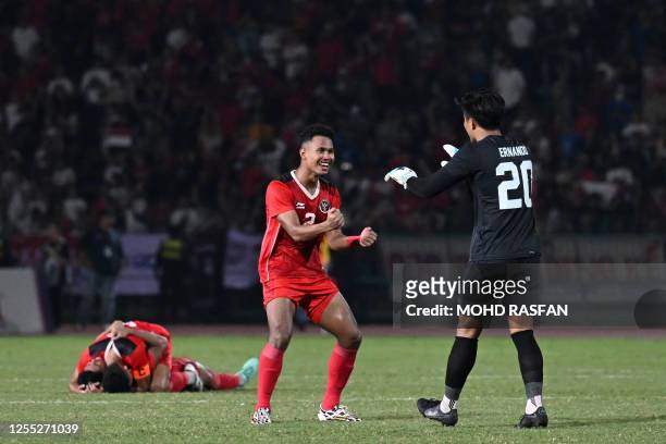 Indonesia's Amiruddin Bagas Kaffa Arrizqi celebrates with goalkeeper Ernando Ari Sutaryadi after beating Thailand in the men's football final match...