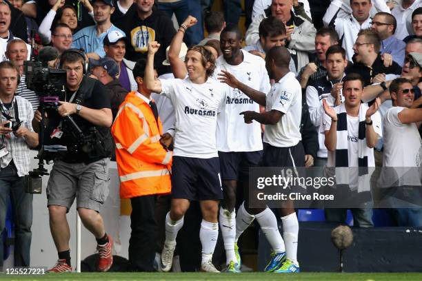 Luka Modric of Tottenham Hotspur celebrates scoring the opening goal with teammates Emmanuel Adebayor and Jermain Defoe during the Barclays Premier...