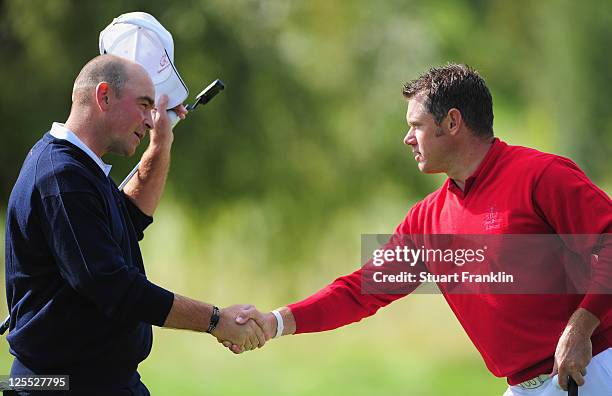 Thomas Bjorn of the Continental Europe team is congratulated by Lee Westwood of the Great Britain and Ireland team during the final day's singles...