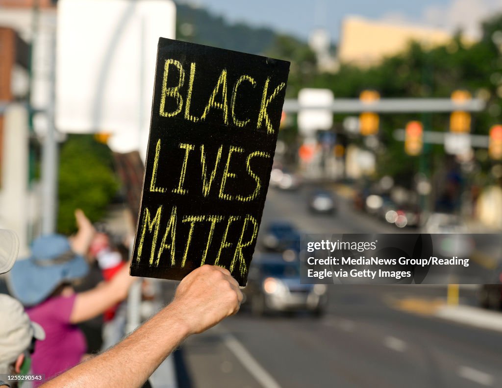 Protesting Racism A protester holds a sign that reads