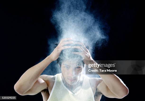 man shaking dandruff powder out of hair - dandruff stock-fotos und bilder