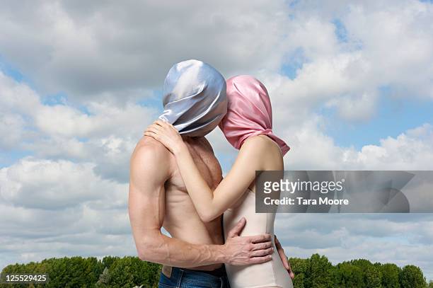 man & woman with faces covered by material kissing - woman whisper to man stock pictures, royalty-free photos & images