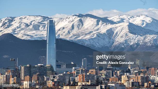 santiago financial district with the snowy andes as background - santiago stock pictures, royalty-free photos & images