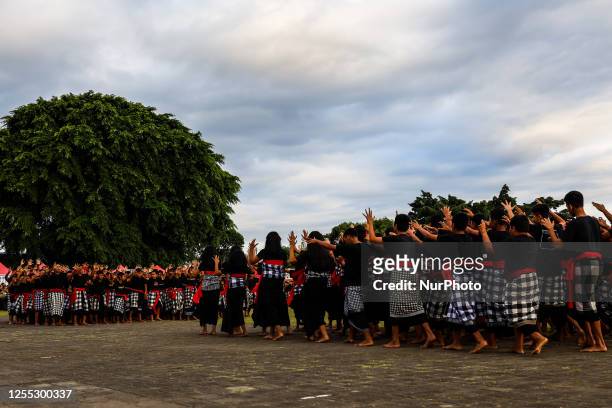 Balinese students dancers raise their arms and chant in a frenzied chorus during the National Education Day in Klungkung, Bali, Indonesia, May 16,...