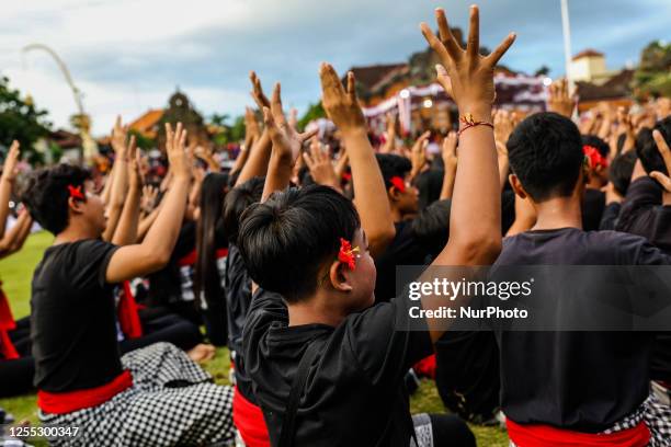 Balinese students dancers raise their arms and chant in a frenzied chorus during the National Education Day in Klungkung, Bali, Indonesia, May 16,...