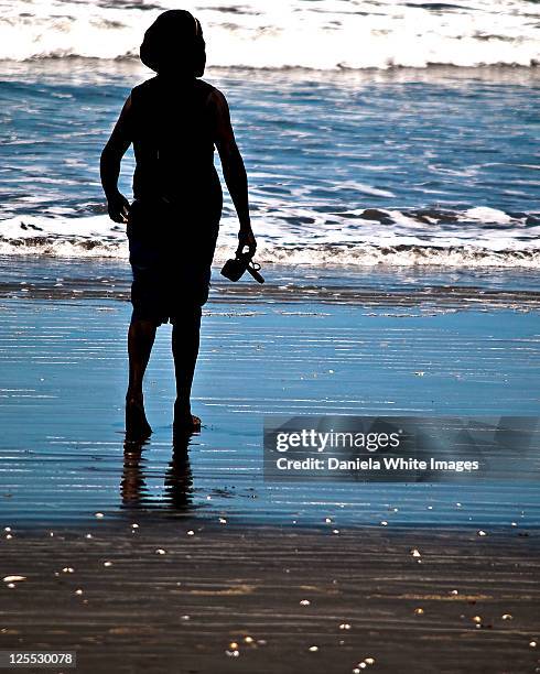 silhouetted on ocean front - bijilo stock pictures, royalty-free photos & images