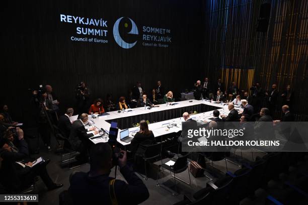 Participants are pictured during the round table "Safeguarding democracy in testing times" at the 4th Summit of the Heads of State and Government of...