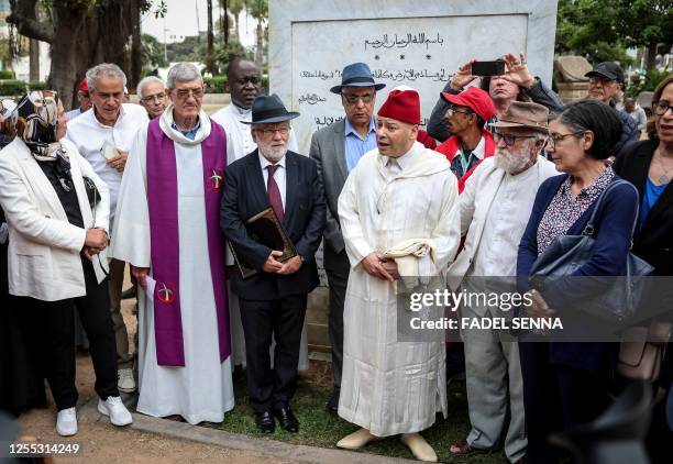 Members of different religious faiths, Muslims, Christians and Jews, gather along victims' associations during a ceremony in Casablanca on May 16 on...