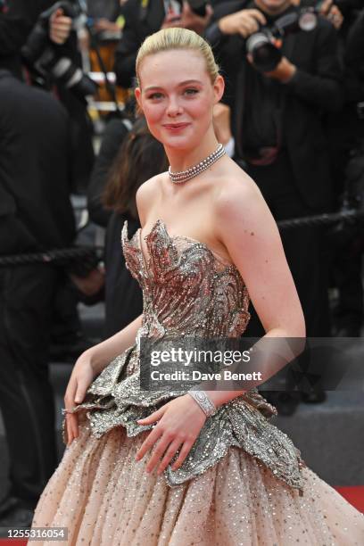 Elle Fanning attends the "Jeanne du Barry" screening & opening ceremony red carpet at the 76th Annual Cannes Film Festival at Palais des Festivals on...