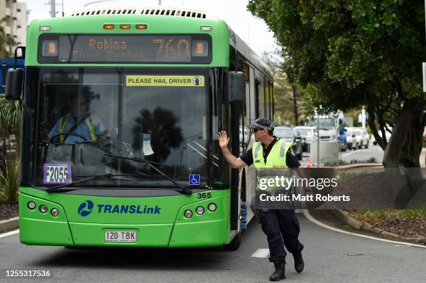 Police are seen stopping a public transport bus to check passengers at the Griffith Street checkpoint at Coolangatta on July 10, 2020 in Coolangatta,...