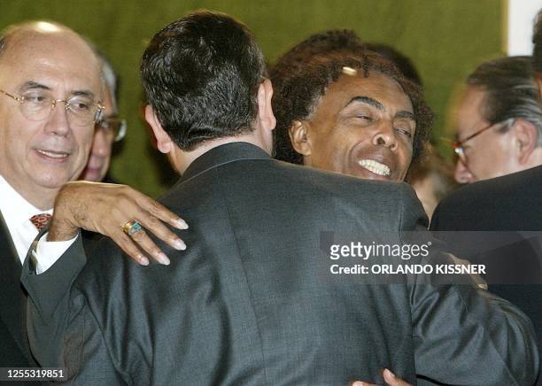 Musician and Culture Minister Gilberto Gil , greets the Economic Minister Antonio Palocci, during his inauguration at the Central Bank in Brasilia,...