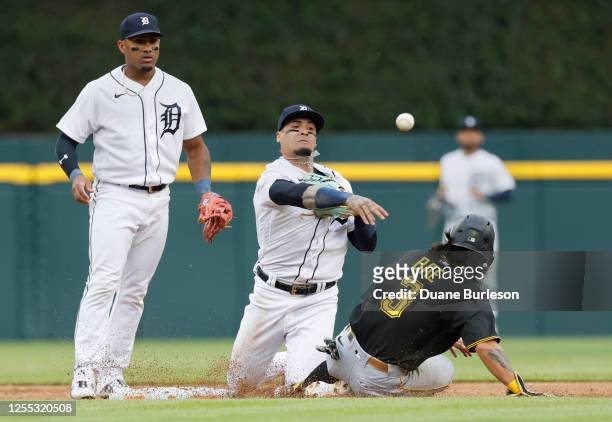 Shortstop Javier Baez of the Detroit Tigers throws the ball for a double play after getting a force out on Ji Hwan Bae of the Pittsburgh Pirates...