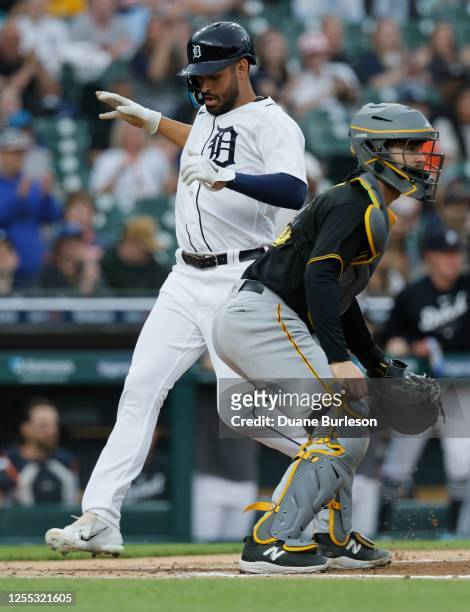 Riley Greene of the Detroit Tigers scores past catcher Jason Delay of the Pittsburgh Pirates on a single by Javier Baez during the first inning at...