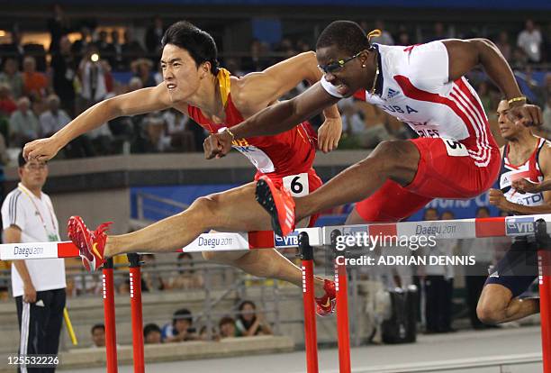 China's Liu Xiang and Cuba's Dayron Robles compete in the men's 110 metres hurdles final at the International Association of Athletics Federations...