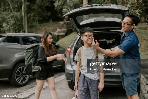 an asian chinese family getting ready for hiking from car park area - family city break stock pictures, royalty-free photos & images