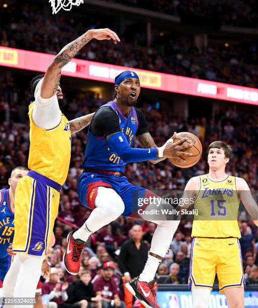 Denver Nuggets guard Kentavious Caldwell-Pope, right, goes up for a layup while Los Angeles Lakers forward Anthony Davis defends during the first...