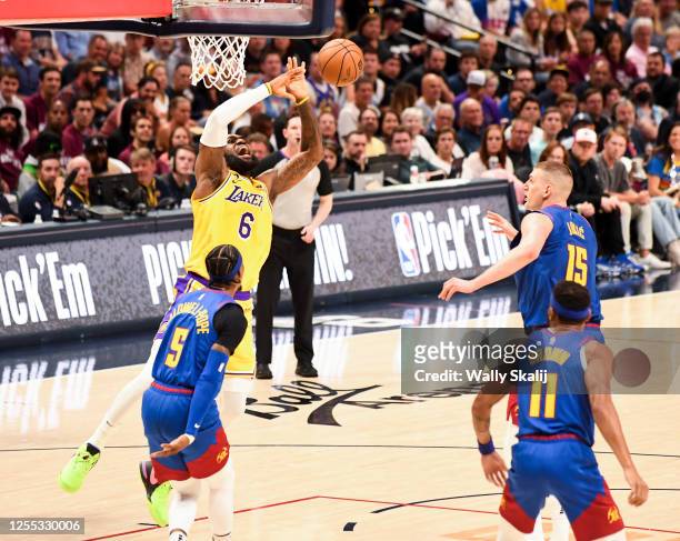 Los Angeles Lakers forward LeBron James, top left, loses the ball while going up to the basket as Denver Nuggets guard Kentavious Caldwell-Pope...