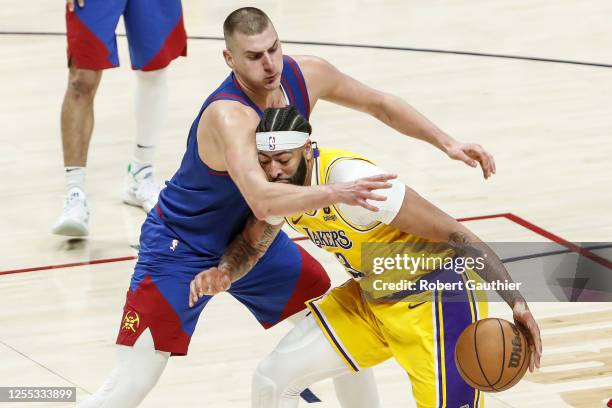 Los Angeles Lakers forward Anthony Davis, right, is defended by Denver Nuggets center Nikola Jokic during the first half of game one in the NBA...