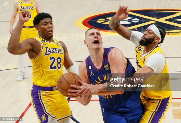Denver, CO, Tuesday, May 16, 2023 - Denver Nuggets center Nikola Jokic is fouled by Los Angeles Lakers forward Anthony Davis late in the game, giving...