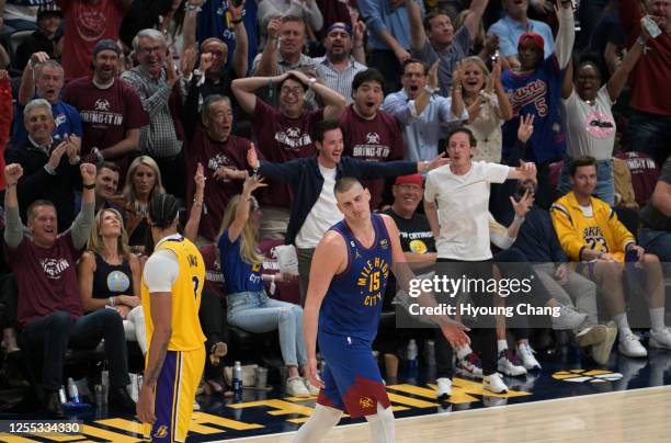 Nikola Jokic of the Denver Nuggets and fans react Jokic's 3 point in the end of 3rd quarter by Anthony Davis of the Los Angeles Lakers during 1st...