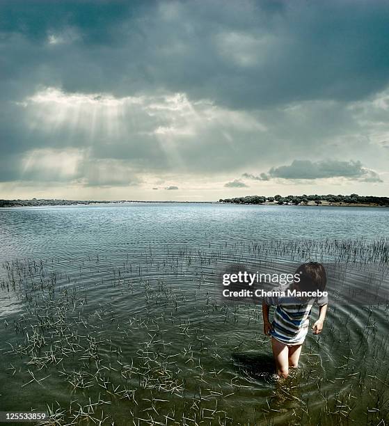 Child Puddle Ripple Boy Water Ripple Photos and Premium High Res Pictures - Getty Images