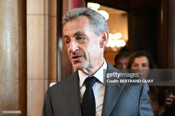 Former French President Nicolas Sarkozy leaves the courthouse after the ruling in his appeal trial in a corruption case at Paris courthouse on May...