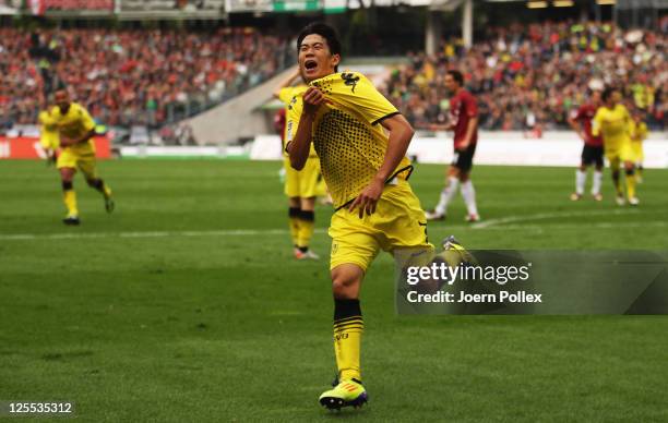 Shinji Kagawa of Dortmund celebrates after scoring his team's first goal during the Bundesliga match between Hanover 96 and Borussia Dortmund at AWD...