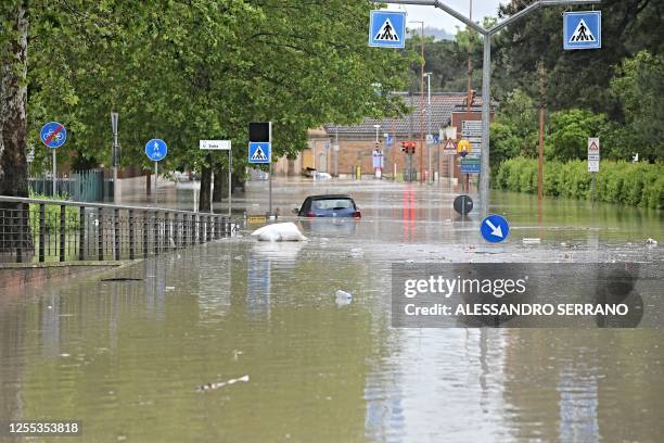 Picture taken in Cesena on May 17, 2023 shows a flooded street after heavy rains have caused major floodings in central Italy, where trains were...