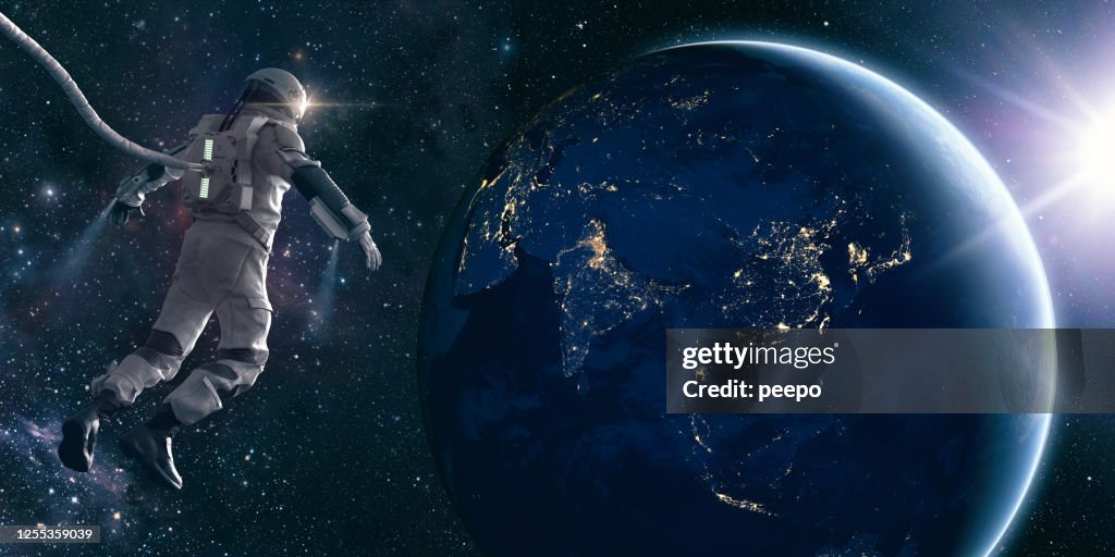 Astronaut On Space Walk Looks At Lights of Planet Earth