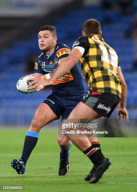 Ashley Taylor of the Titans looks to offload the ball during the round nine NRL match between the Gold Coast Titans and the New Zealand Warriors at...