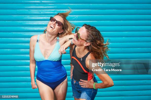 two mature women in swimwear laughing - middle aged woman bathing suit stock pictures, royalty-free photos & images