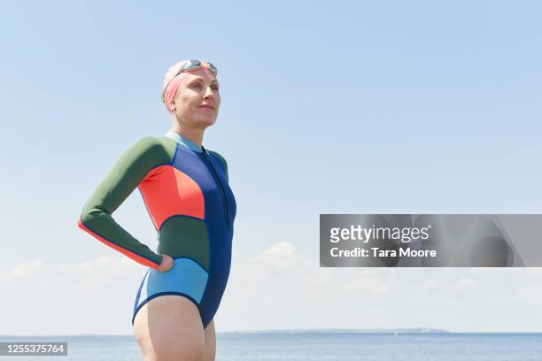 mature woman in wetsuit looking out to sea - disabilitycollection ストックフォトと画像
