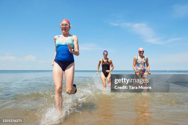 mature women running in sea - only mature women stock pictures, royalty-free photos & images