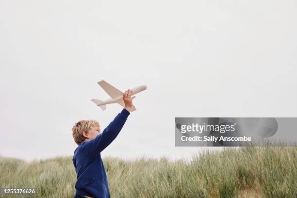 child playing with a toy aeroplane - model airplane stock pictures, royalty-free photos & images
