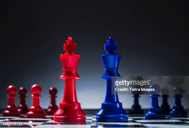 studio shot of red and blue chess pawns symbolizing us democratic and republican parties - democrate stock pictures, royalty-free photos & images