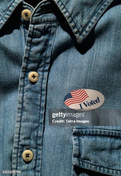 close-up of i voted sticker on denim shirt - denim shirt stock pictures, royalty-free photos & images