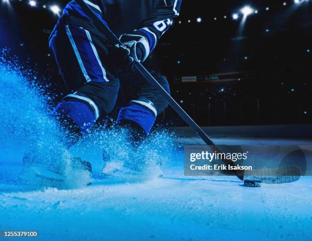 hockey player on ice - puck stock-fotos und bilder