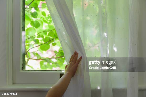 girl (6-7) opening curtain - open day 6 stock pictures, royalty-free photos & images