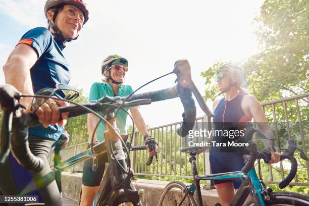 three mature women with racing bicycles - cycle race stock pictures, royalty-free photos & images